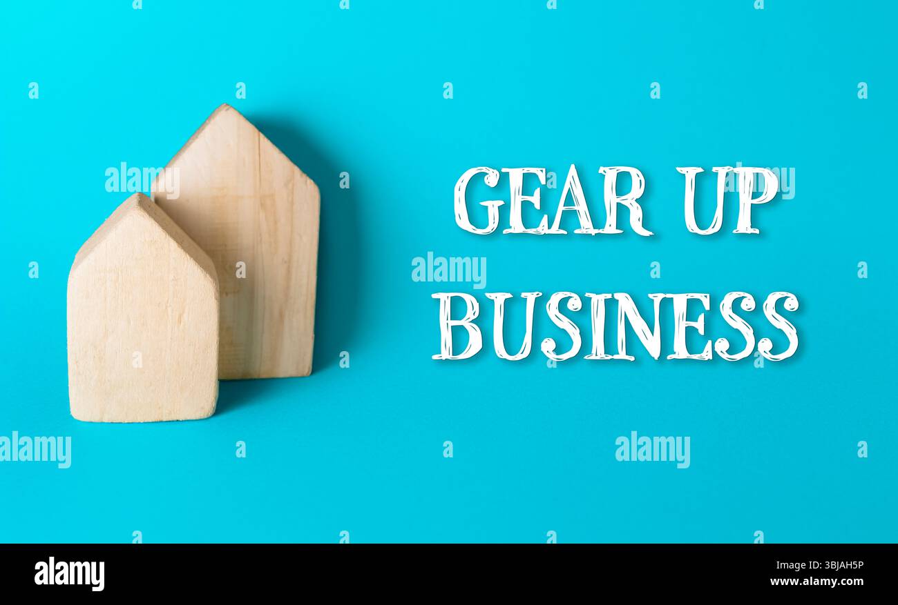 Due case di legno sono su sfondo blu con le parole "attrezzate business" scritte sotto di loro Foto Stock