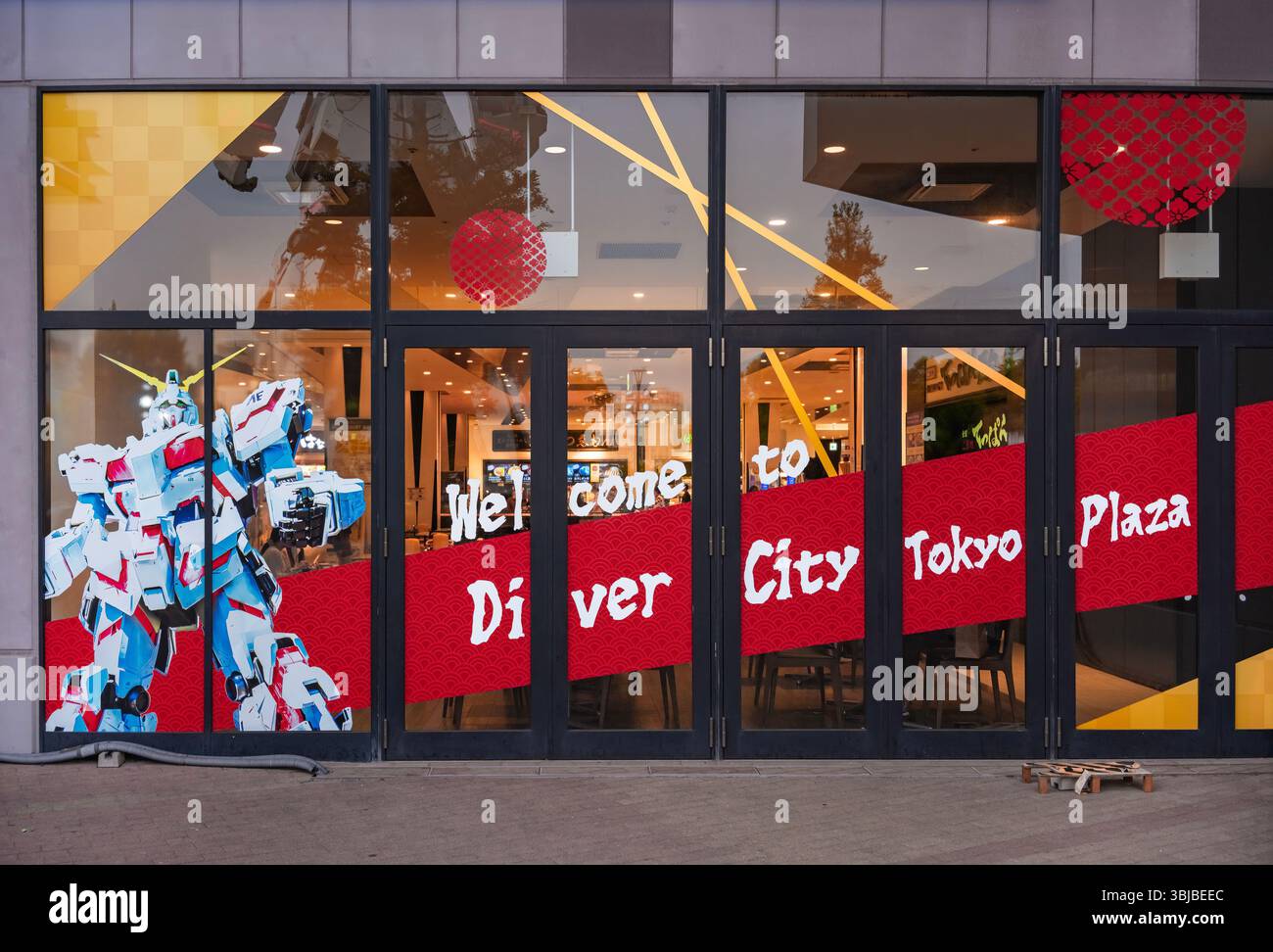 tokyo, odaiba - 22 maggio 2025: L'ingresso di DiverCity Tokyo Plaza presenta una facciata in vetro con un grande adesivo UNICORN GUNDAM che mostra l'enfatizzina Foto Stock