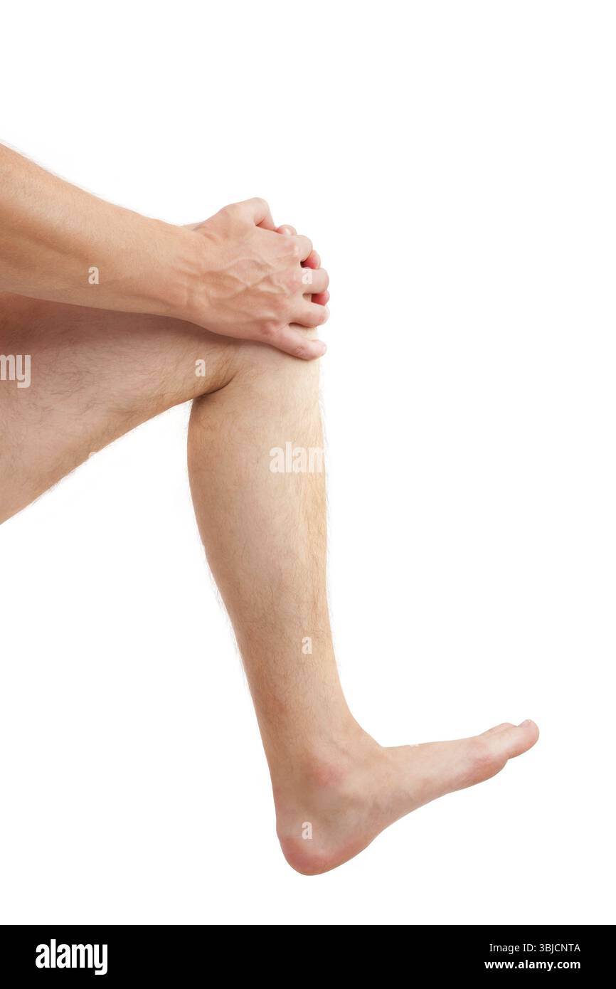 Bell'uomo che tiene il ginocchio ferito isolato su sfondo bianco. Lesione al ginocchio Foto Stock