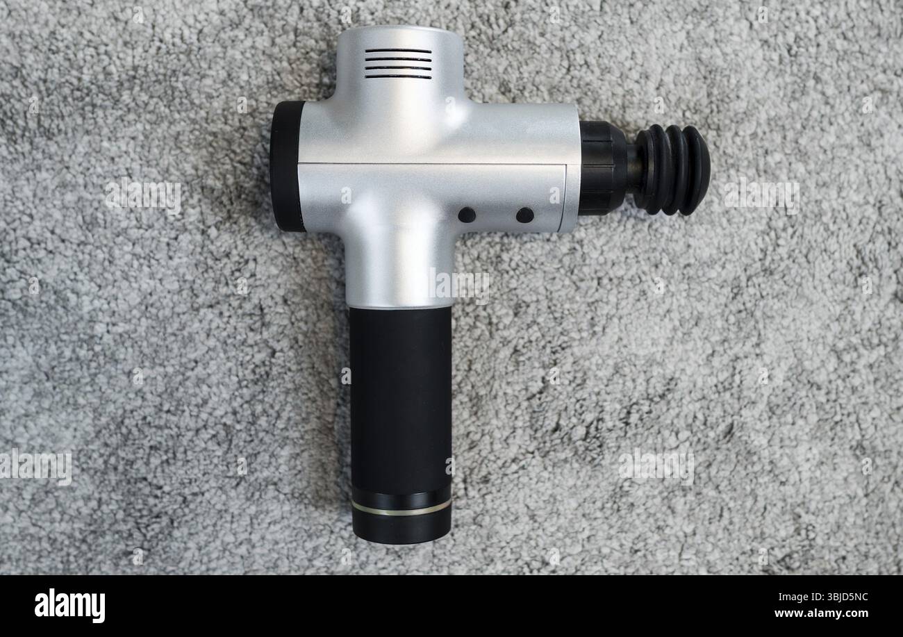 Ðœassage percussioni o cannone. Per il dolore muscolare e il rilassamento della rigidità Foto Stock