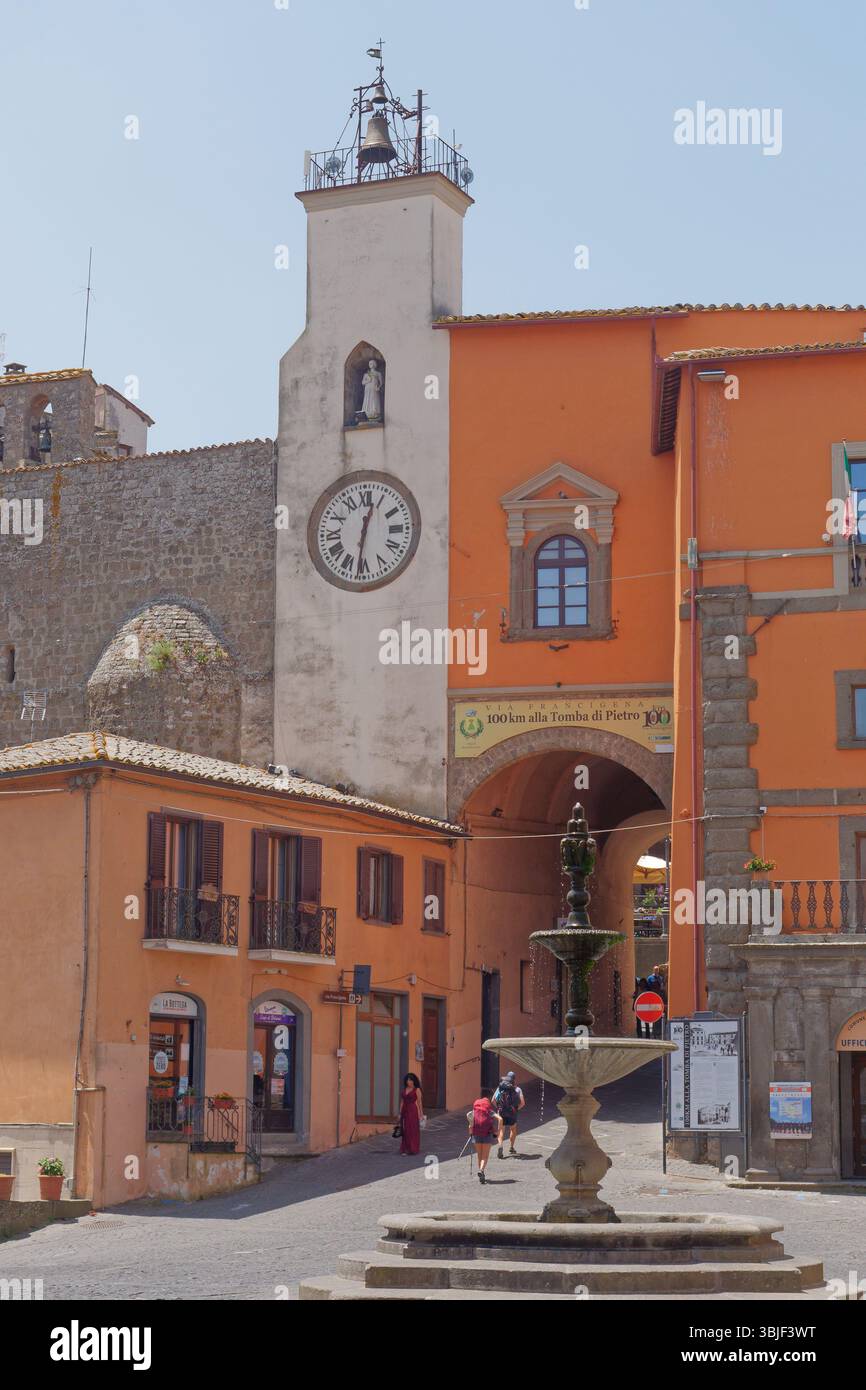 Il miglior vestito della domenica delle donne e i pellegrini camminano attraverso la piazza principale di una domenica dopo la messa a Montefiascone, regione Lazio, Italia. 15 giugno 2025 Foto Stock