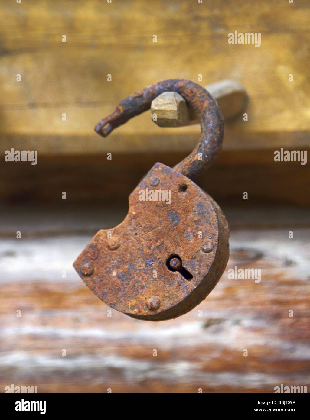 Antico lucchetto vintage arrugginito su fondo in legno. Serratura a cerniera anticata vintage arrugginita Foto Stock