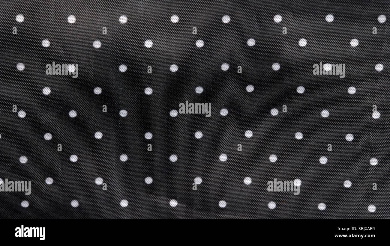 Tessuto nero lo sfondo con puntini bianchi Foto Stock