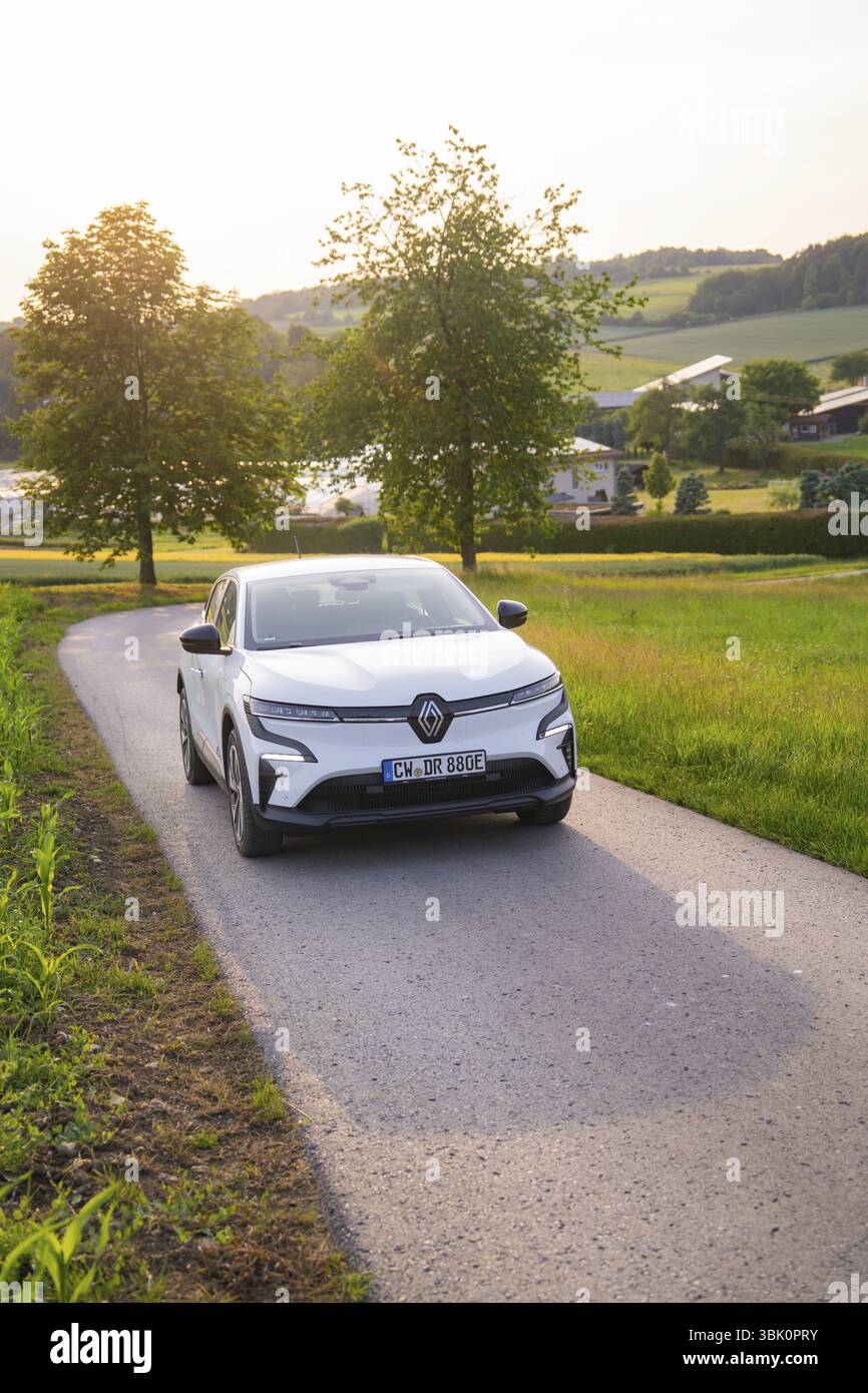Auto bianca al tramonto su una strada di campagna, circondata da alberi, Renault Megane, Deer e- Carsharing, auto elettrica, Gechingen, Germania, Europa Foto Stock