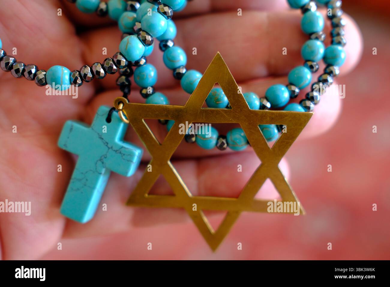 Due religioni monoteiste, il cristianesimo e l'ebraismo. Un rosario e una stella di David. Simboli religiosi. Foto Stock