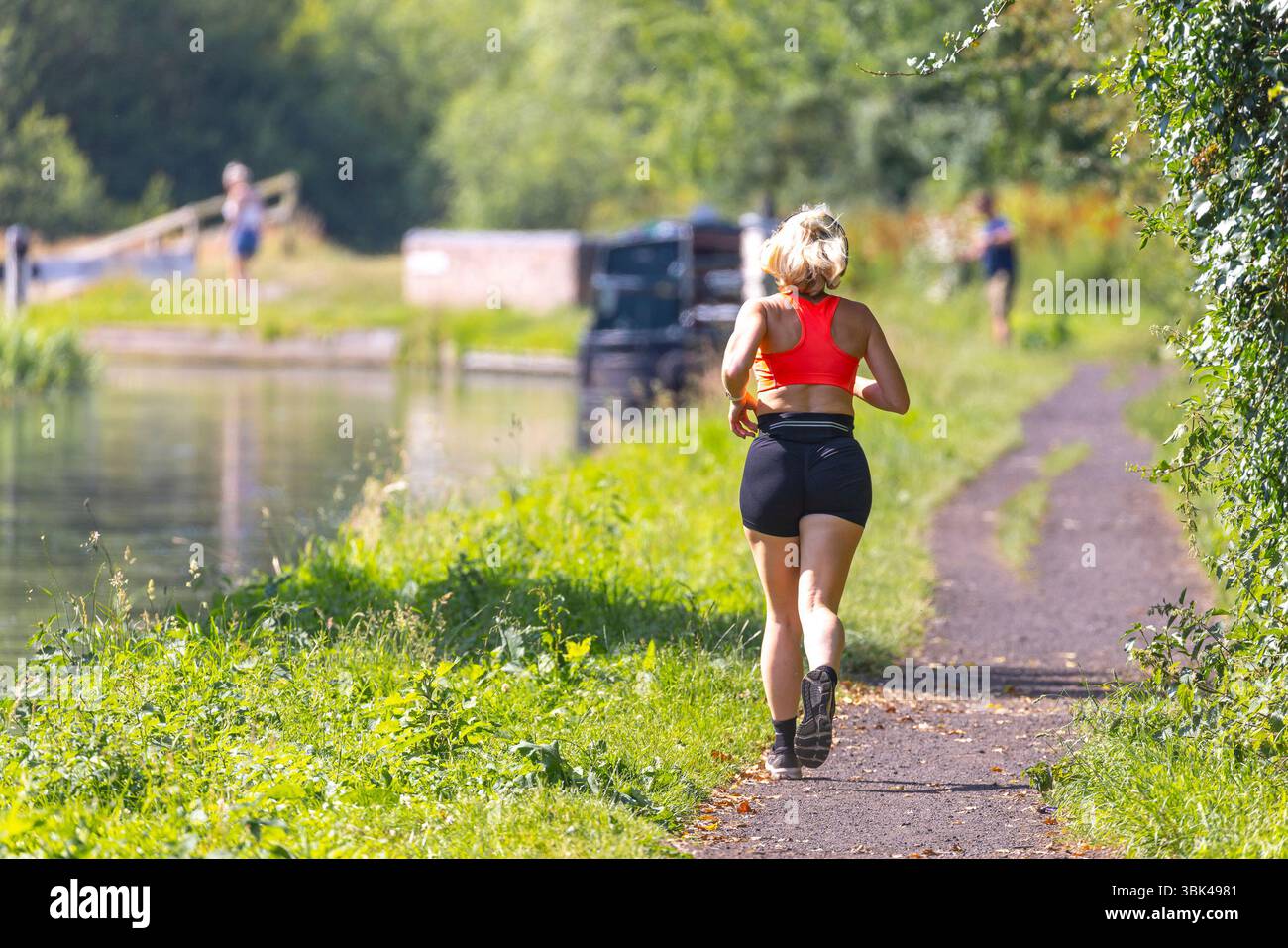 Kidderminster, Regno Unito. 18 giugno 2024. Meteo nel Regno Unito: I jogger corrono su un sentiero lungo il canale durante una giornata di sole a giugno nelle Midlands. La temperatura sta aumentando oggi, raggiungendo rapidamente 25 gradi celsius molto comodi. Crediti: Lee Hudson/Alamy Live News Foto Stock