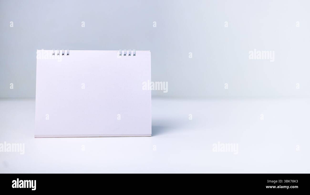Un calendario bianco vuoto su una superficie pulita, che simboleggia i nuovi inizi, la pianificazione futura, la pianificazione e le date chiave. Concetti di gestione del tempo, produzione Foto Stock