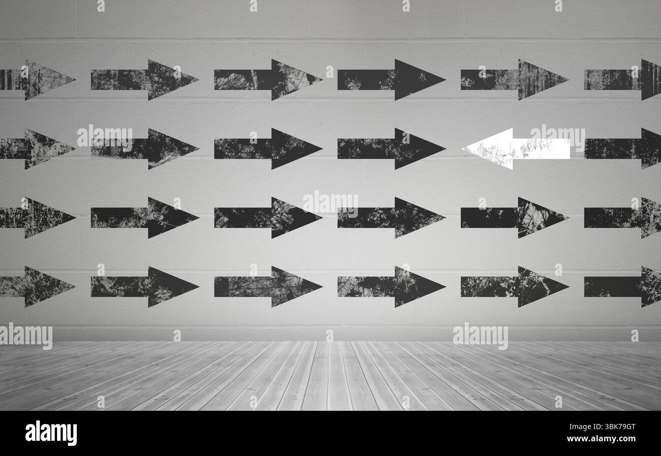 Frecce bianche e nere sulla parete Foto Stock