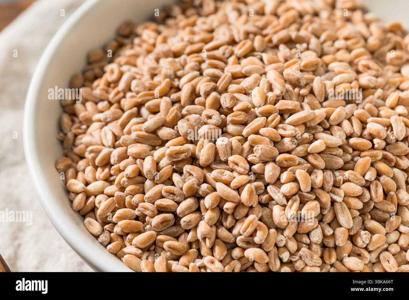 Farro crudo biologico in una ciotola Foto Stock