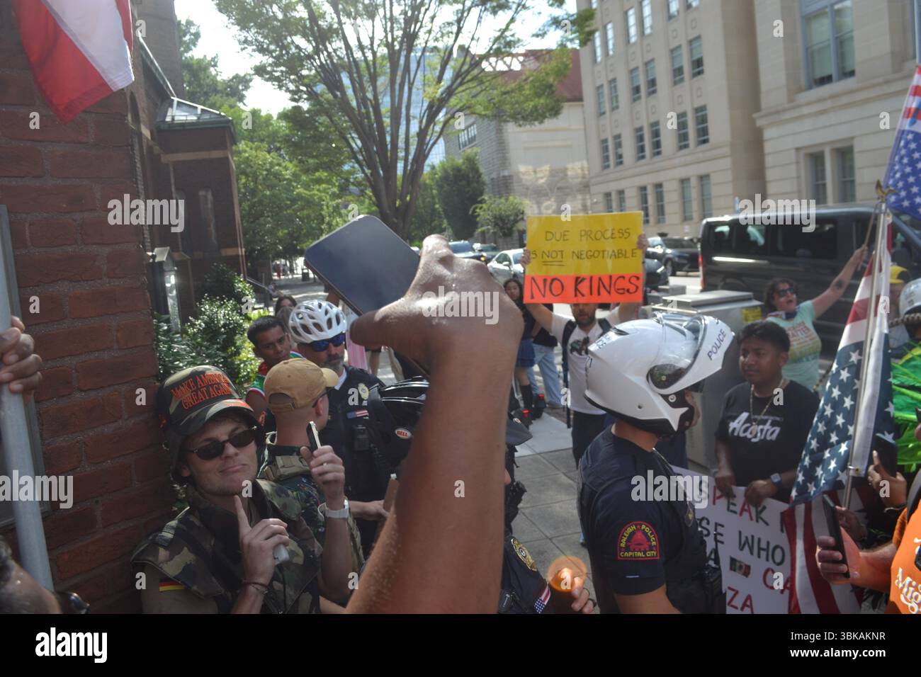 La polizia di Raleigh costituisce una barriera per proteggere due contro-manifestanti al NO KINGS RALLY a Capitol Square, nel centro di Raleigh, Carolina del Nord. Foto Stock