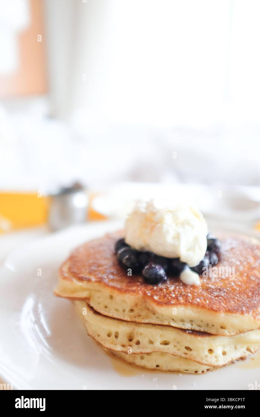 Pila di pancake con mirtilli e burro al limone Foto Stock