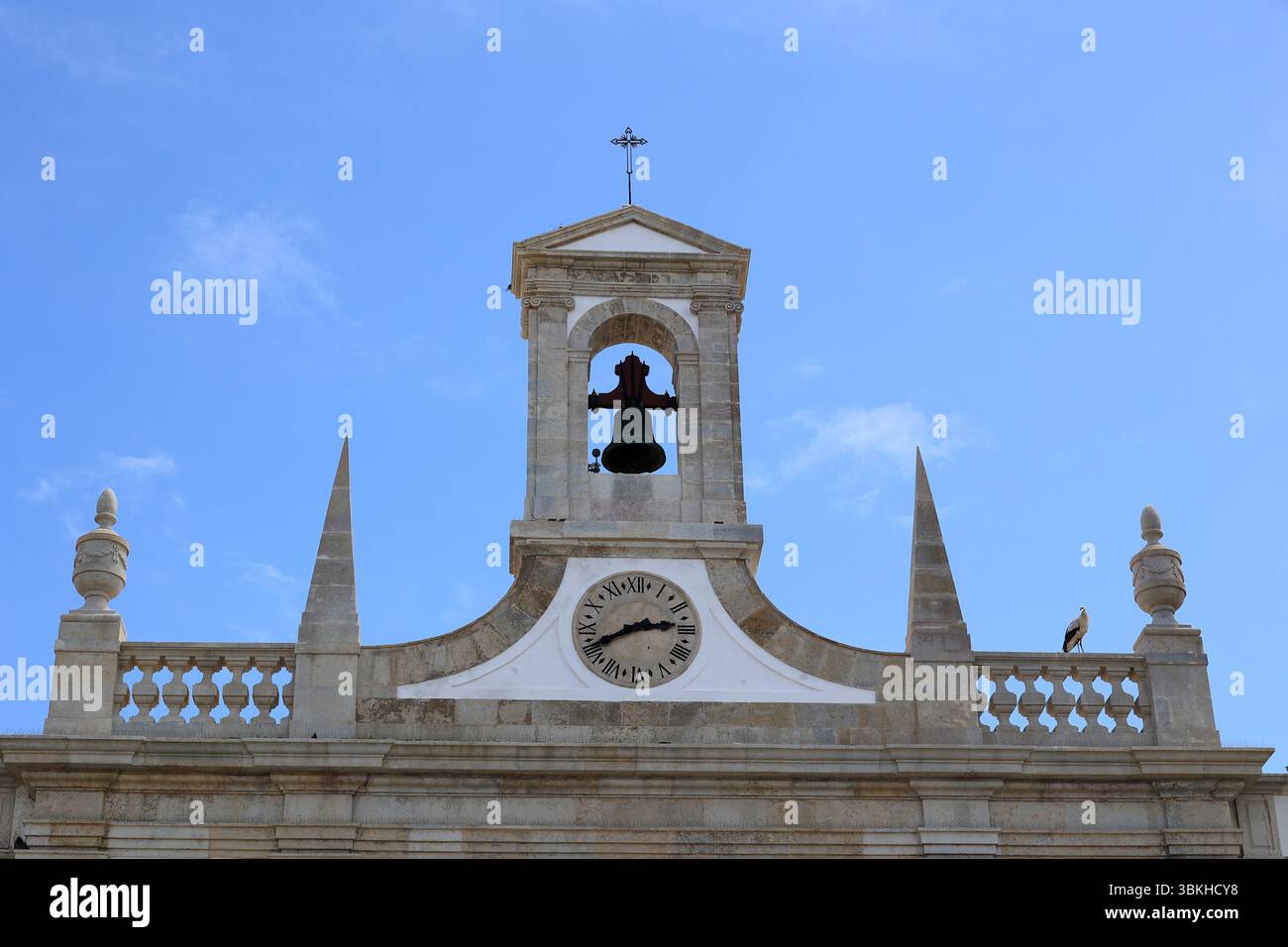 Facciata con campana e orologio dall'Arco da Vila a Faro, Portogallo Foto Stock