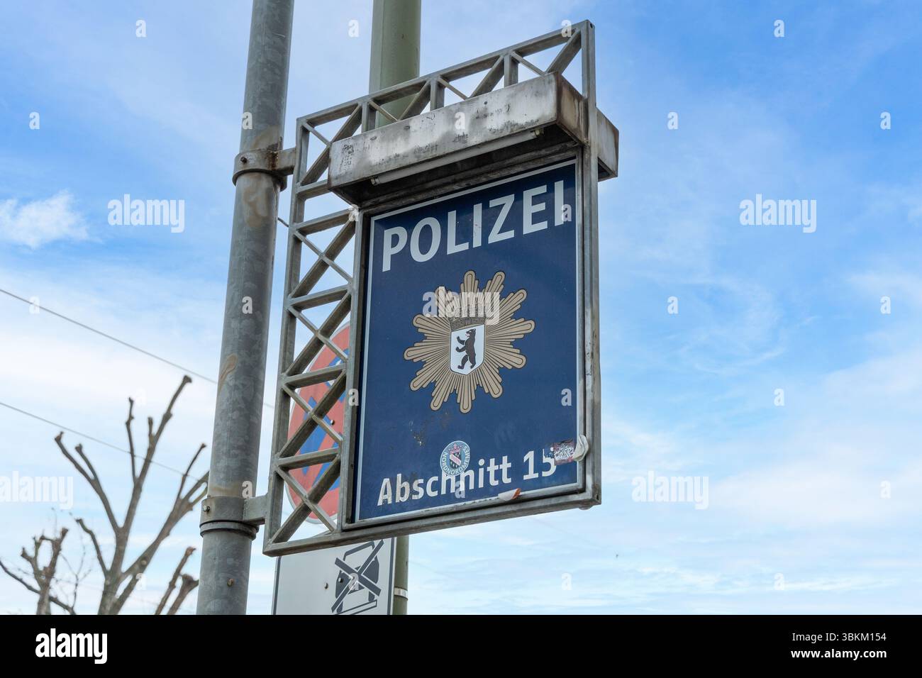 Segno di una stazione di polizia tedesca "Polizei", Abschnitt 15, a Berlino. Il cartello blu presenta l'emblema della polizia con uno stemma di orso, incorniciato da un filo metallico Foto Stock