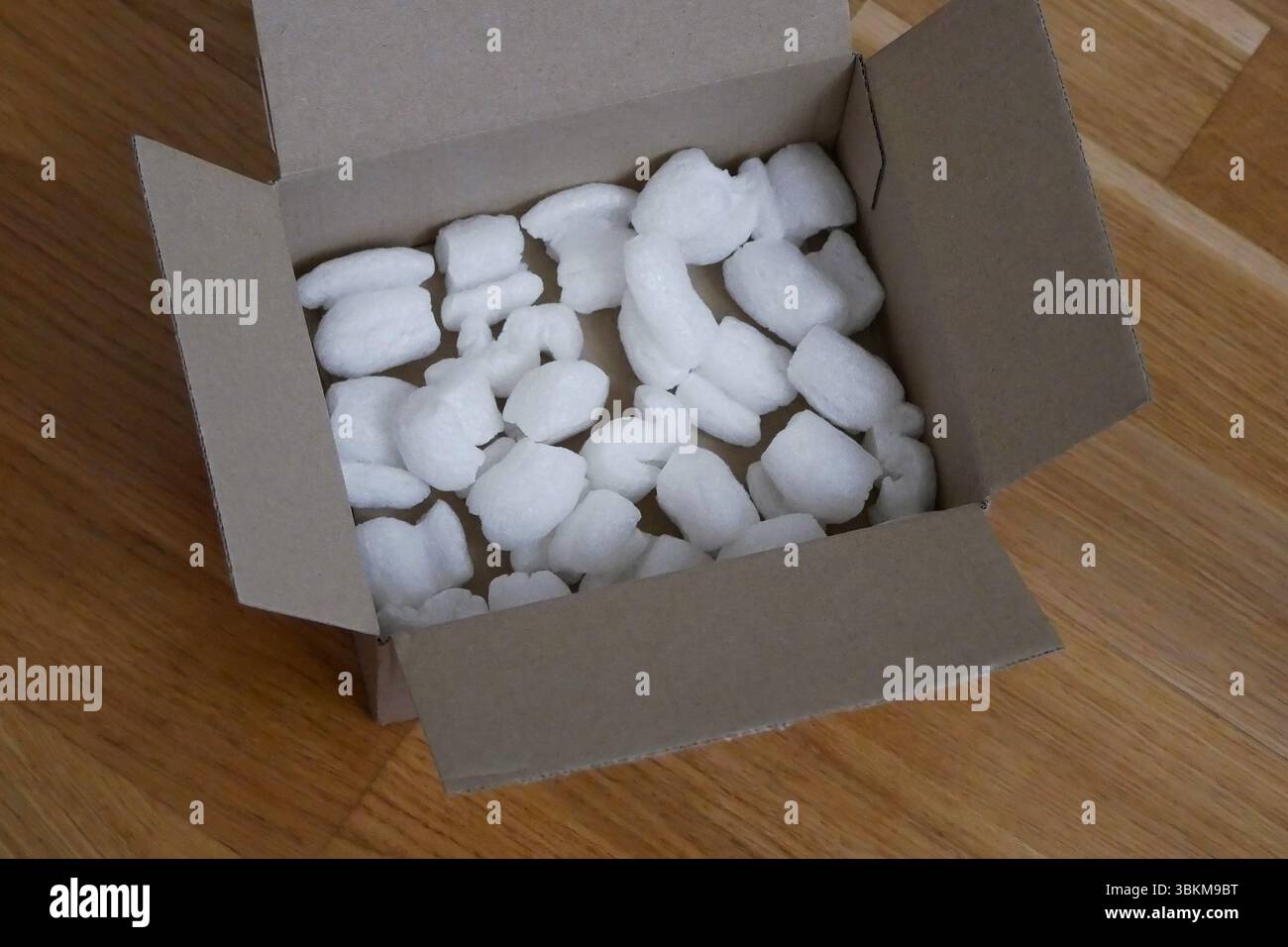 Imballaggio ecologico di una scatola per pacchi riempita con riempitivo biodegradabile. Il concetto di servizio di consegna e riciclaggio. Foto Stock
