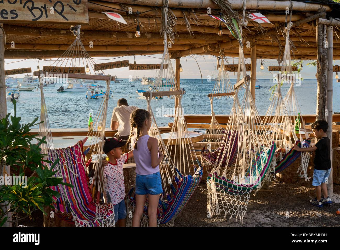 Straßen-Restaurant an der Promenade, Hängesessel und Kinder, Puerto Baquerizo Moreno, Isla San Cristóbal, Islas Galápagos, Ecuador Foto Stock
