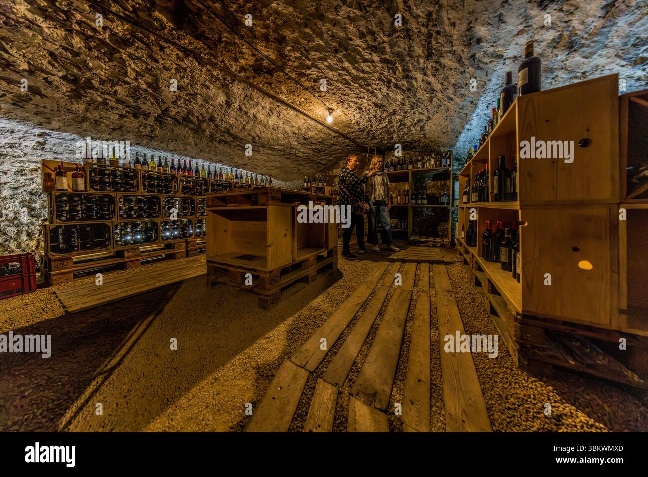 Cantina self-service presso il ristorante Auberge Chez cUL de Paille a Poitiers. Gli ospiti vanno nella cantina e scelgono una bottiglia di vino per accompagnare il loro pasto. I prezzi sono indicati sulle scatole dei vini. Gli ospiti portano la bottiglia al loro tavolo, dove viene aperta dal personale. Una delle caratteristiche speciali dell'Auberge le cUL de Paille è che gli ospiti possono scegliere il proprio vino da tavola in cantina e che molti artisti famosi, come Jaques Brel, si sono immortalati sulle pareti con autografi, detti e disegni. Rue Théophraste Renaudot, Poitiers, Nouvelle-Aquitaine, fra Foto Stock