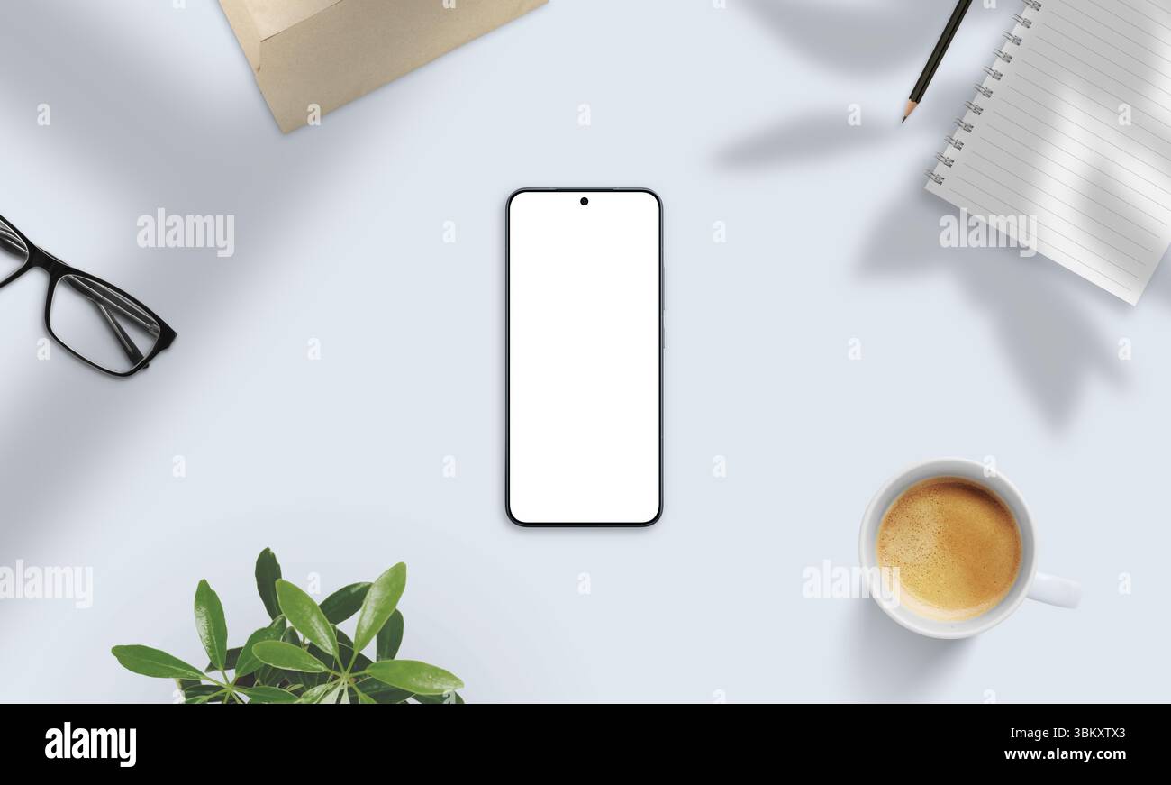 Mockup smartphone su una scrivania con luce soffusa con caffè, bicchieri, notebook e ombre. Perfetto per la presentazione naturale di app e contenuti digitali Foto Stock