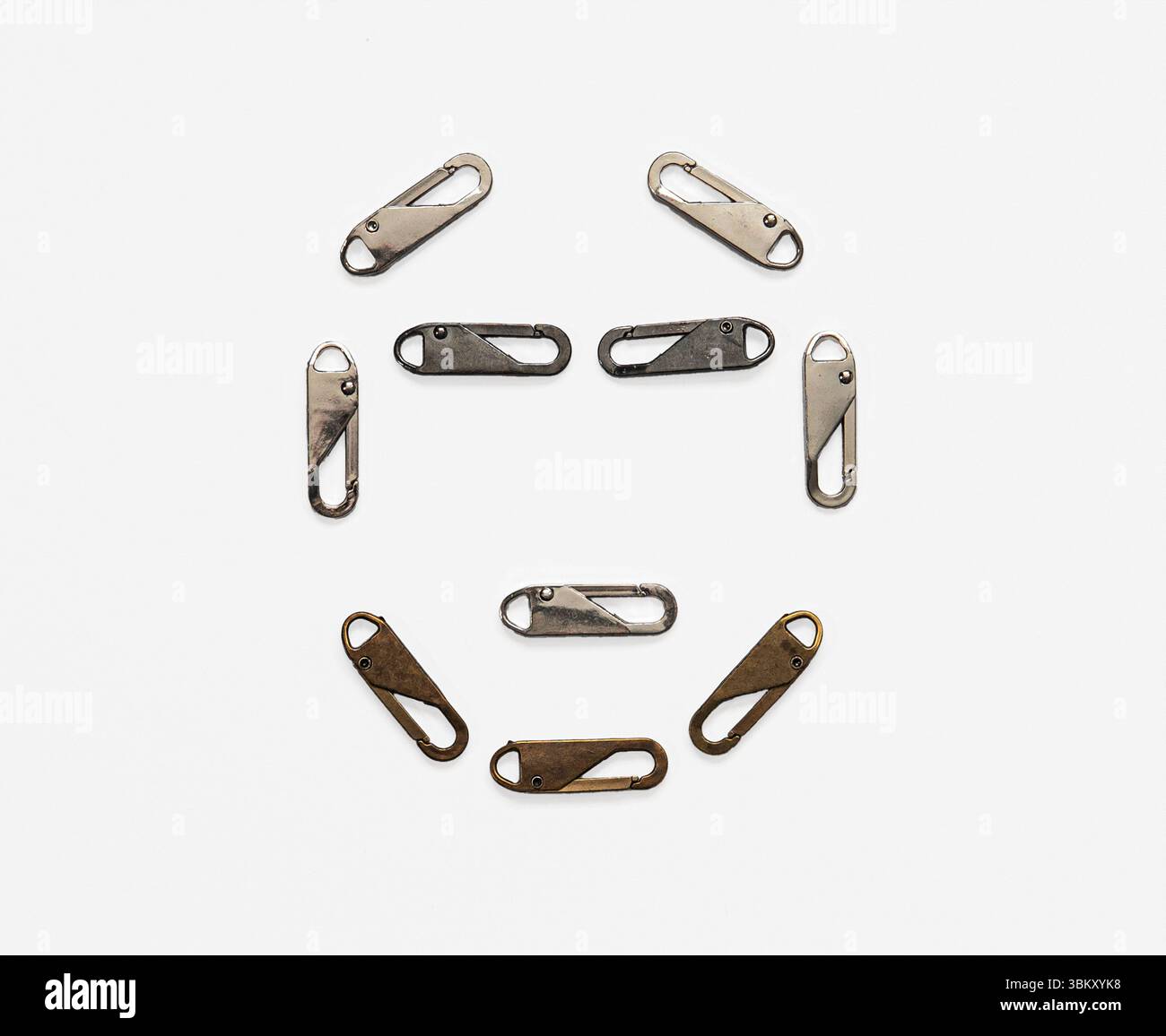 Faccia umana astratta in moschettone metallico con clip per portachiavi. Concetto di ritratto industriale surreale che simboleggia connettività e identità. Foto Stock