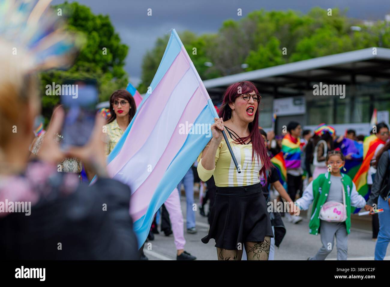Una donna trans alza la bandiera transgender con orgoglio durante la LGBT+ Pride March della città. L'immagine rappresenta l'empowerment, la visibilità e l'id del sesso Foto Stock