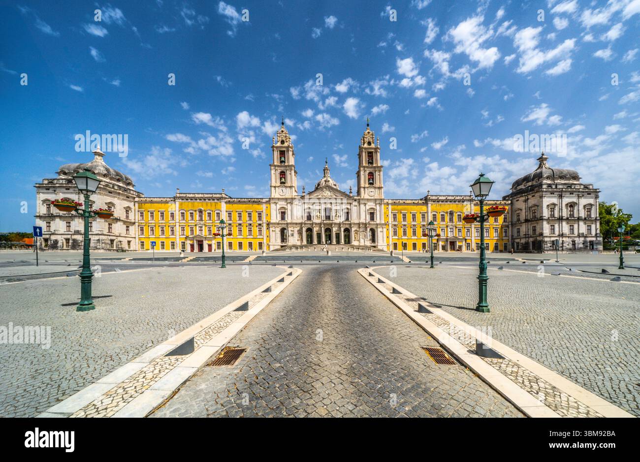 Palazzo Nazionale di Mafra, Portogallo. Complesso reale grande barocco e neoclassico con basilica e torri gemelle sotto un cielo blu. Patrimonio mondiale dell'UNESCO. Foto Stock