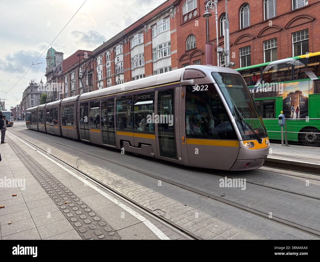 Tram Luas sui binari della città di Dublino. Include edifici, altri veicoli e persone, raffiguranti i trasporti pubblici urbani e i viaggi. Foto Stock