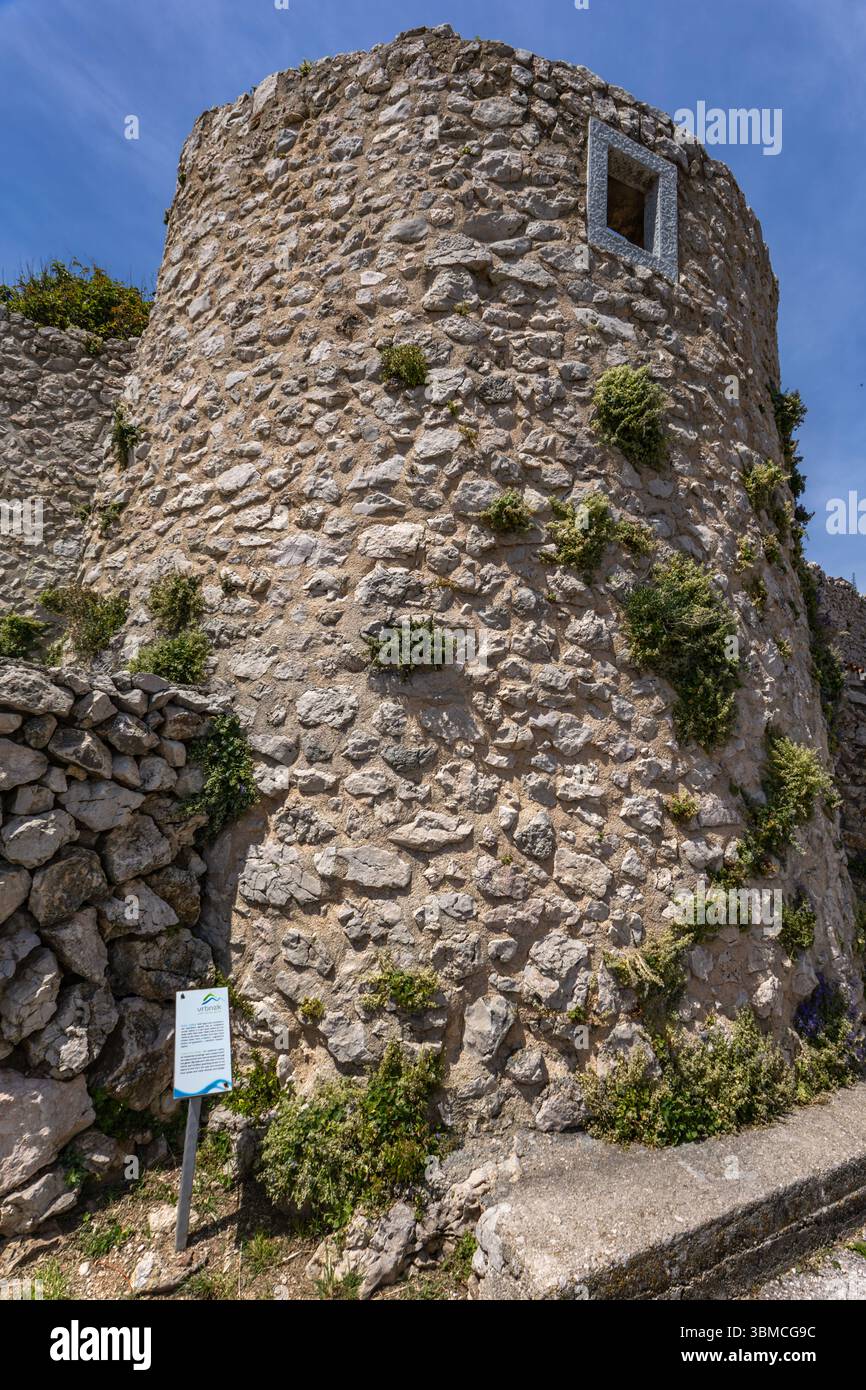 Le mura che circondano la città vecchia di Vrbnik sull'isola di KRK, i monumenti e gli edifici in pietra della città, una passeggiata attraverso le stradine strette Foto Stock