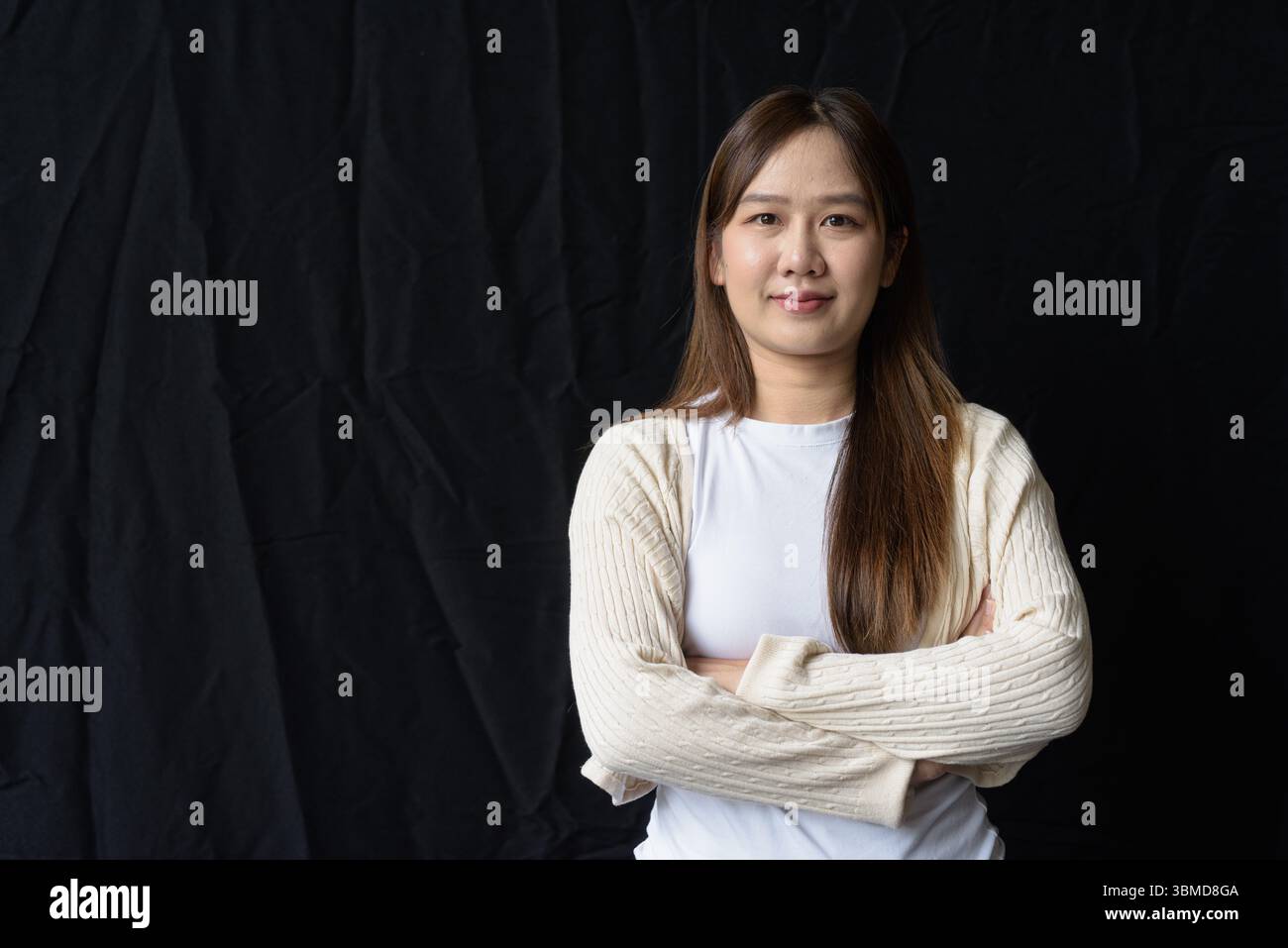 Ritratto in studio di una giovane donna asiatica su sfondo scuro Foto Stock