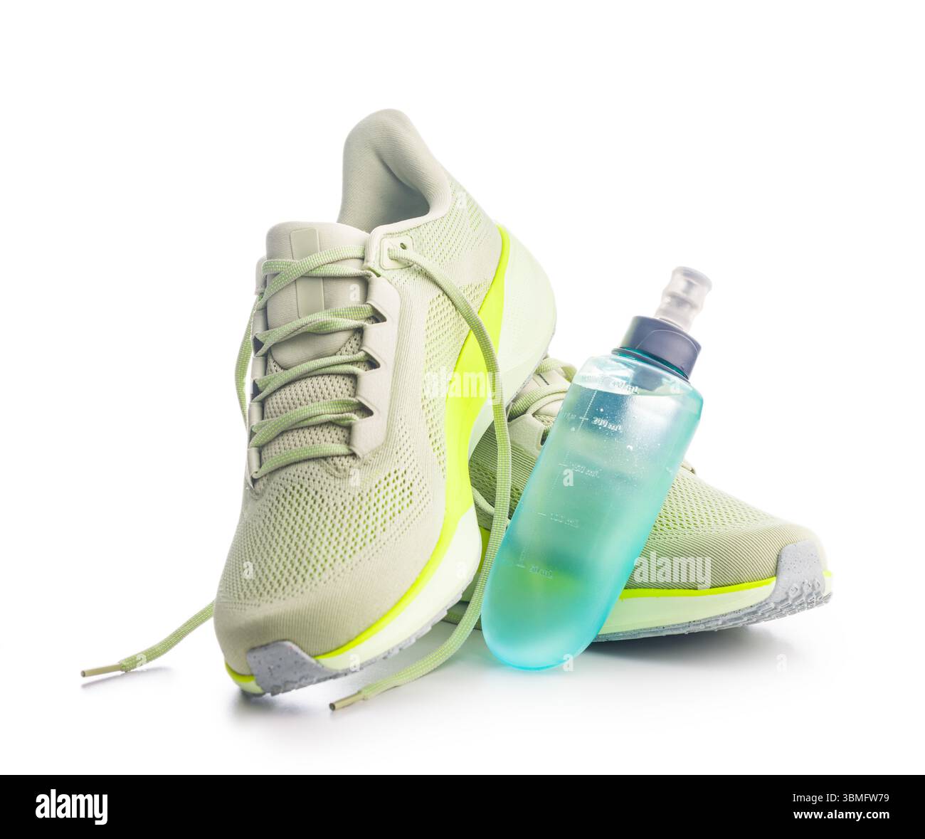Scarpe da running sportive e bottiglia d'acqua isolata su sfondo bianco. Foto Stock