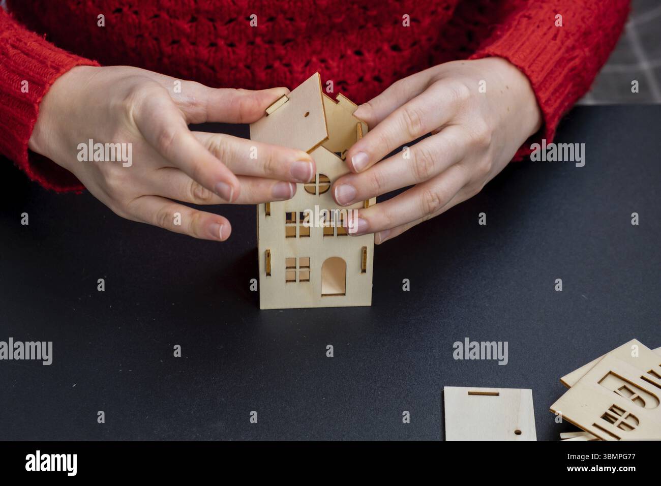 Processo di preparazione per Natale e Capodanno. Case in legno artigianali in 3D fai da te. Decorazioni ecologiche ecologiche ecologiche a zero rifiuti fatte a mano. Hobby per bambini Foto Stock