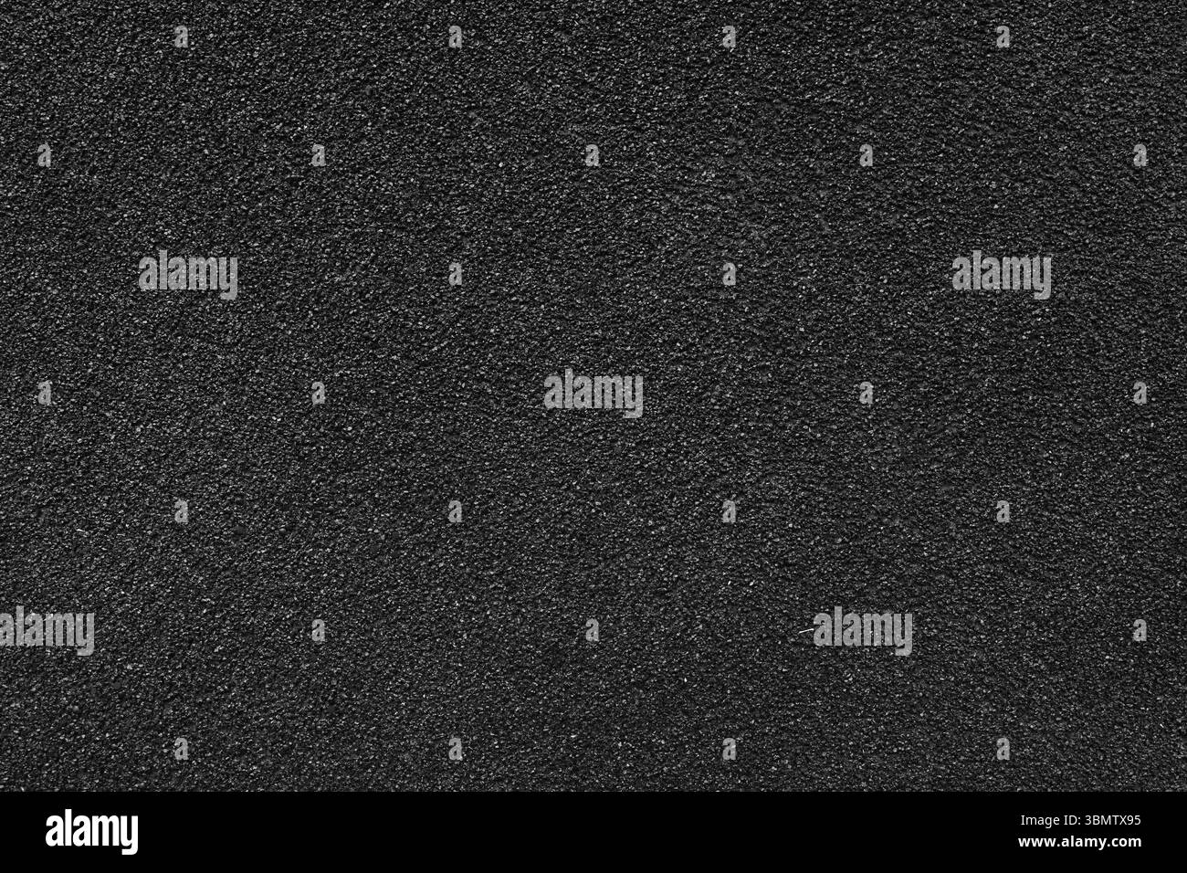 Granulosità di asfalto, intonaco, cemento, plastica, roccia, primo piano di pietra, macro. Sfondo della superficie granulare nera della parete, sfondo ruvido Foto Stock