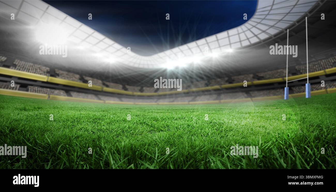 Lo stadio coperto dal design piatto presenta proiettori che illuminano il campo verde con pali da rugby Foto Stock