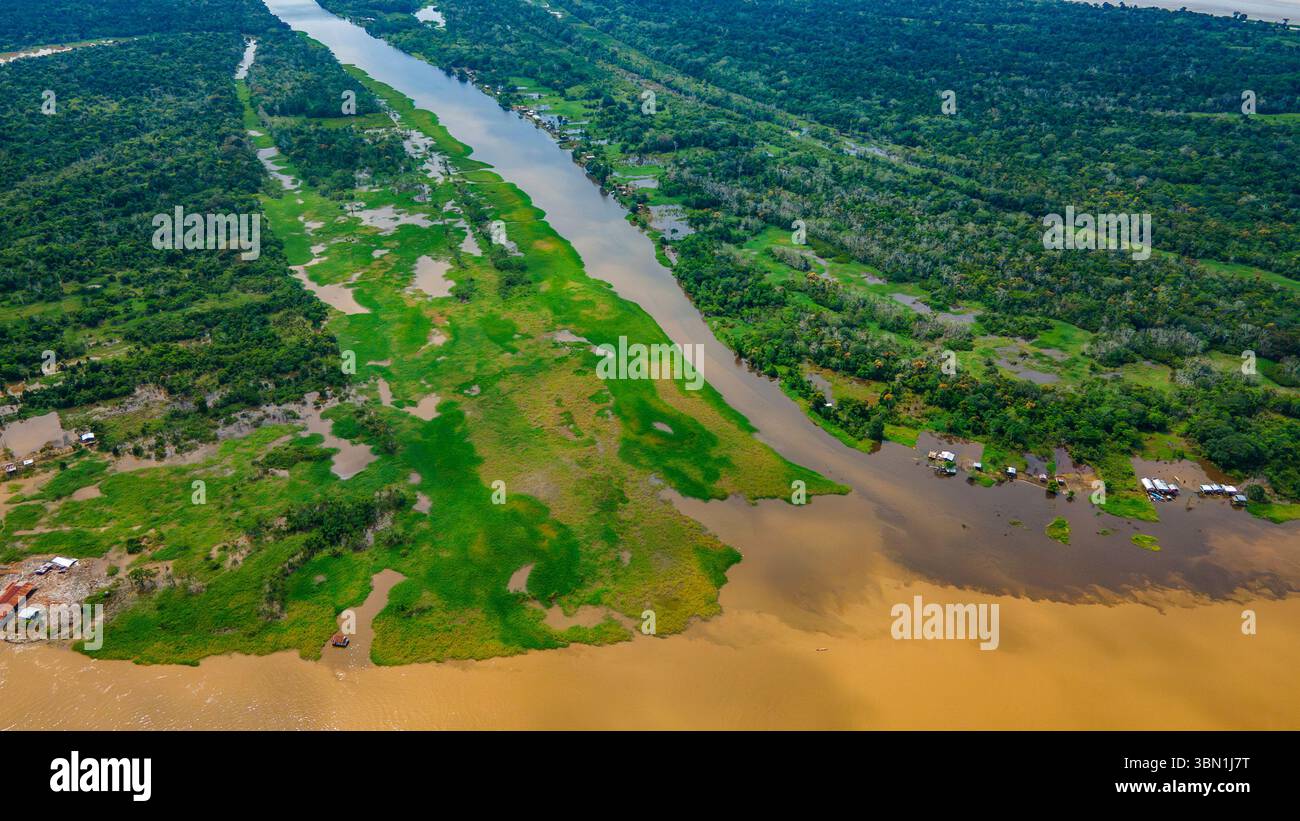 Splendida vista aerea del Rio delle Amazzoni che si fonde con lussureggianti paesaggi verdi ad Amazonas, Colombia. In mostra la biodiversità e la bellezza della natura. Foto Stock