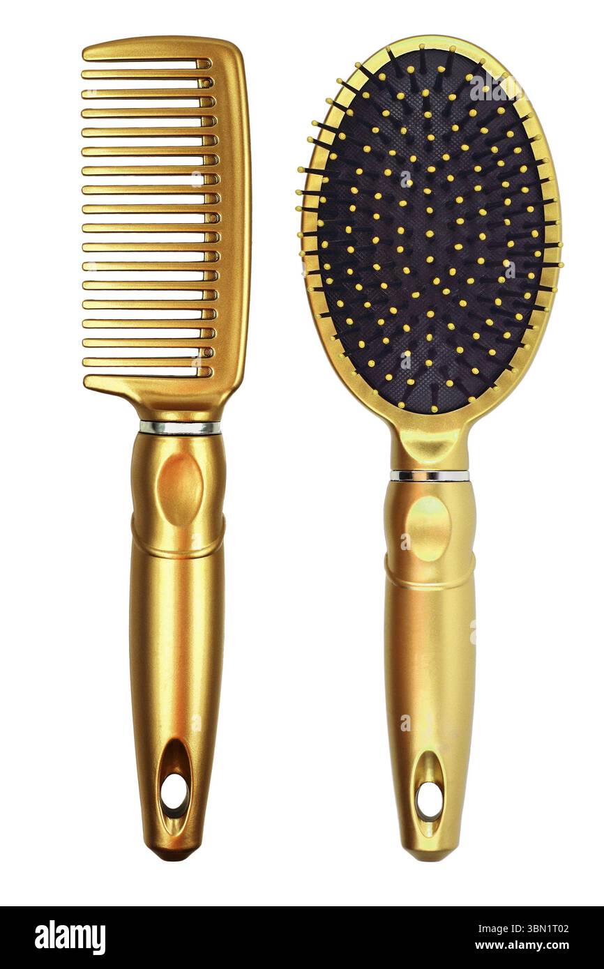 Sono due pettini d'oro isolati sul bianco. Foto Stock
