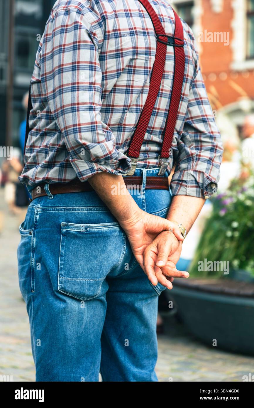 Uomo, mani in acqua con camicia a scacchi e bretelle Foto Stock