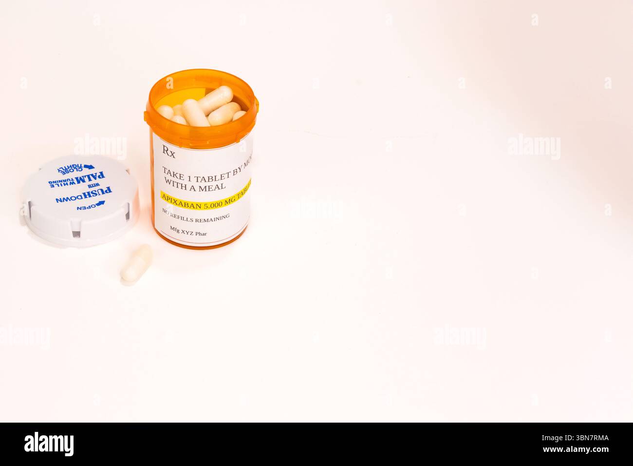 Un contenitore di prescrizione APIXABAN con una capsula davanti. Vista dall'alto. Foto Stock