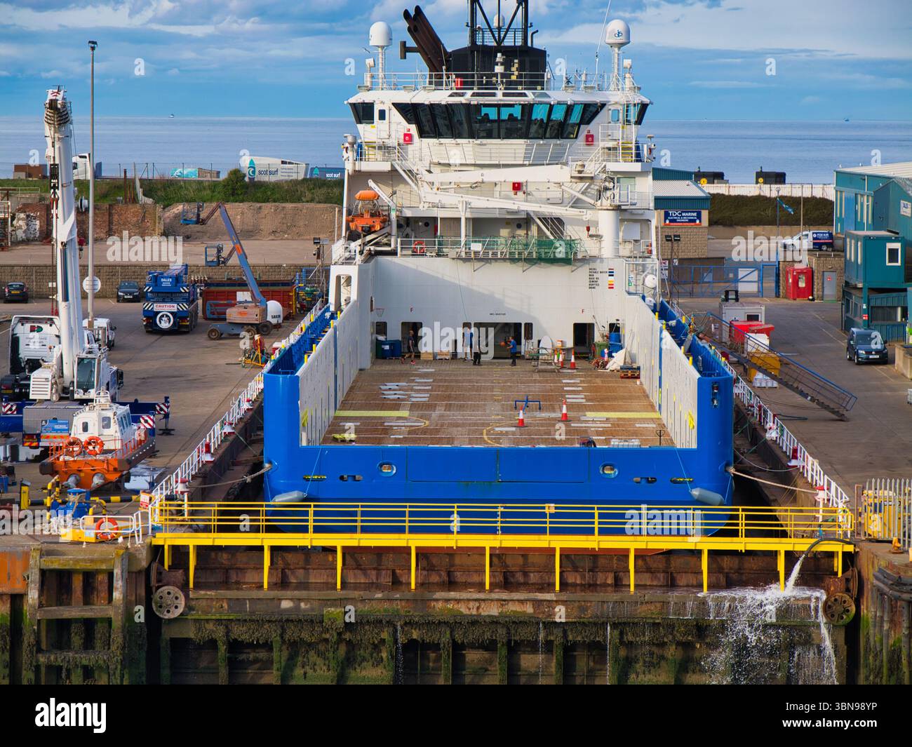 Aberdeen, Scozia - maggio 28 2025: Al porto di Aberdeen lo spazioso ponte merci di una nave di servizio offshore in un porto vivace Foto Stock