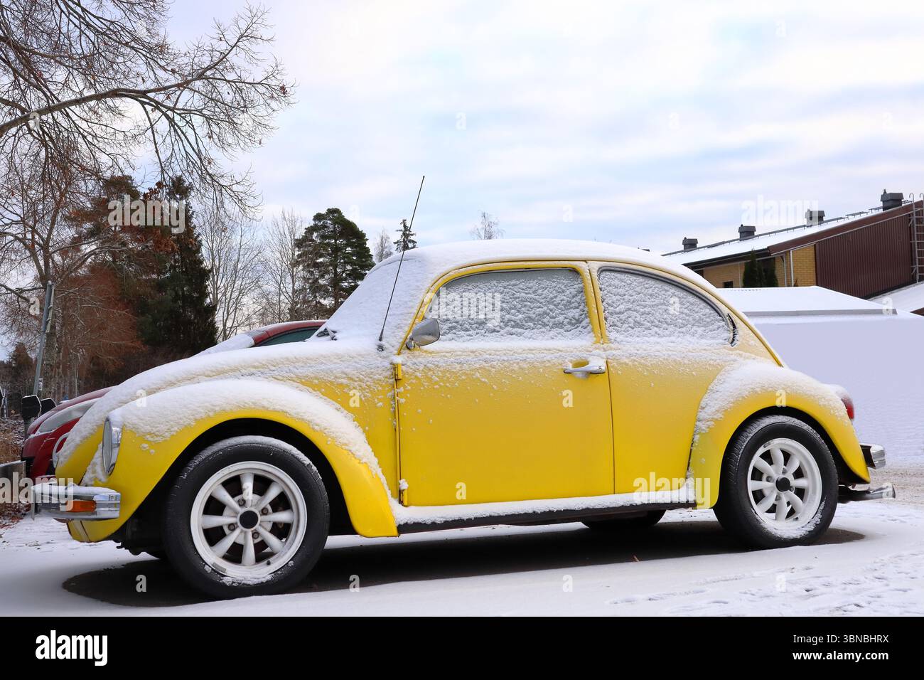 Uno scarabeo Volkswagen giallo o una bolla ricoperta di neve. Veicolo vecchio stile. Simbolo classico. Clima freddo. Foto Stock