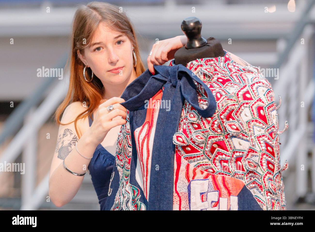 Londra, Regno Unito. 2 luglio 2025. Madelaine-Rose Walker, studentessa della Royal School of Needlework, dà il tocco finale al suo design, che presenta le parole "Fell in Love". I laureati del Regno Unito in più di 100 corsi universitari presenteranno i loro progetti dell'ultimo anno nelle prossime due settimane al Business Design Centre, mentre il New Designers Show celebra il suo 40° anniversario. Le mostre della prima settimana riguardano moda e costumi, artigianato, tessuti, gioielli e metalli, ceramiche e vetro. Crediti: Imageplotter/Alamy Live News Foto Stock