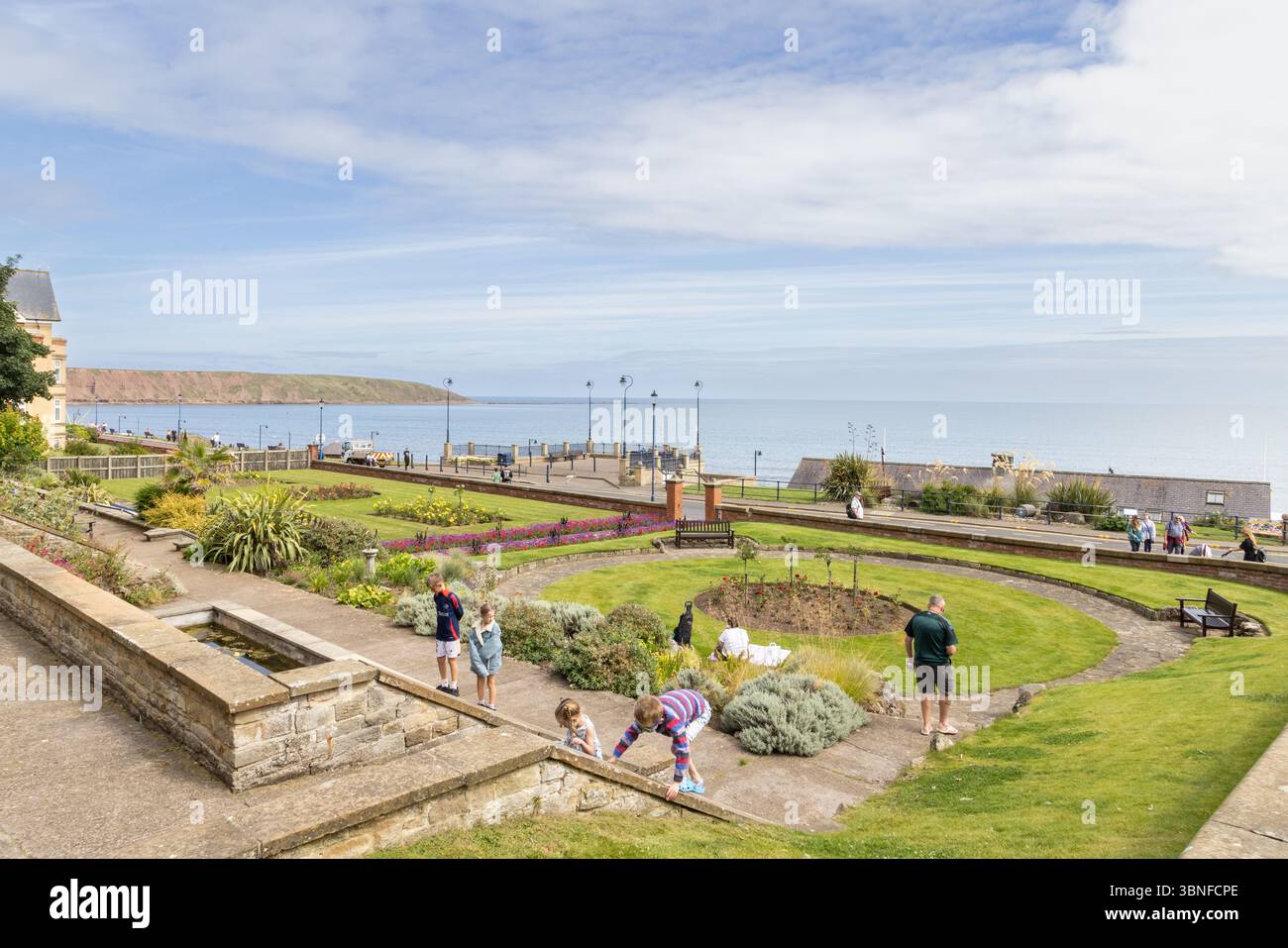 Una vista dei Crescent Gardens che si affacciano su Filey Bay e Filey Brigg sulla costa dello Yorkshire, con ampie vedute sul mare e sul promontorio. Foto Stock