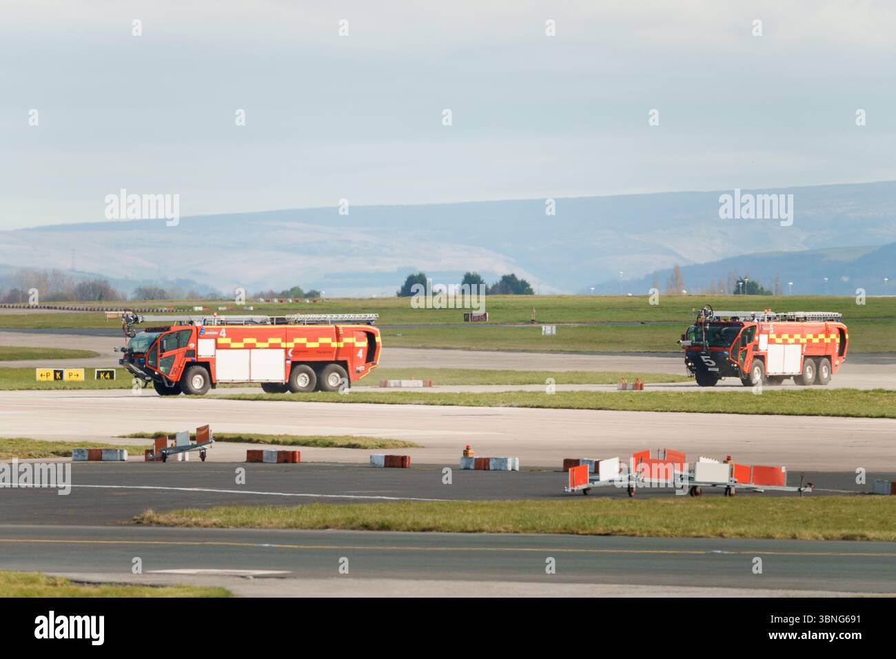 I vigili del fuoco attraversano la pista all'aeroporto di Manchester Foto Stock