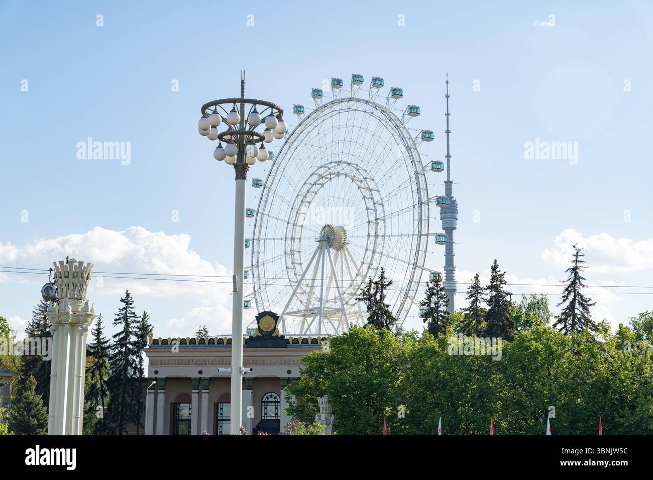 Vista panoramica della Mostra dei risultati dell'economia nazionale (VDNKH) a Mosca, Russia, con una grande ruota panoramica sullo sfondo di lu Foto Stock