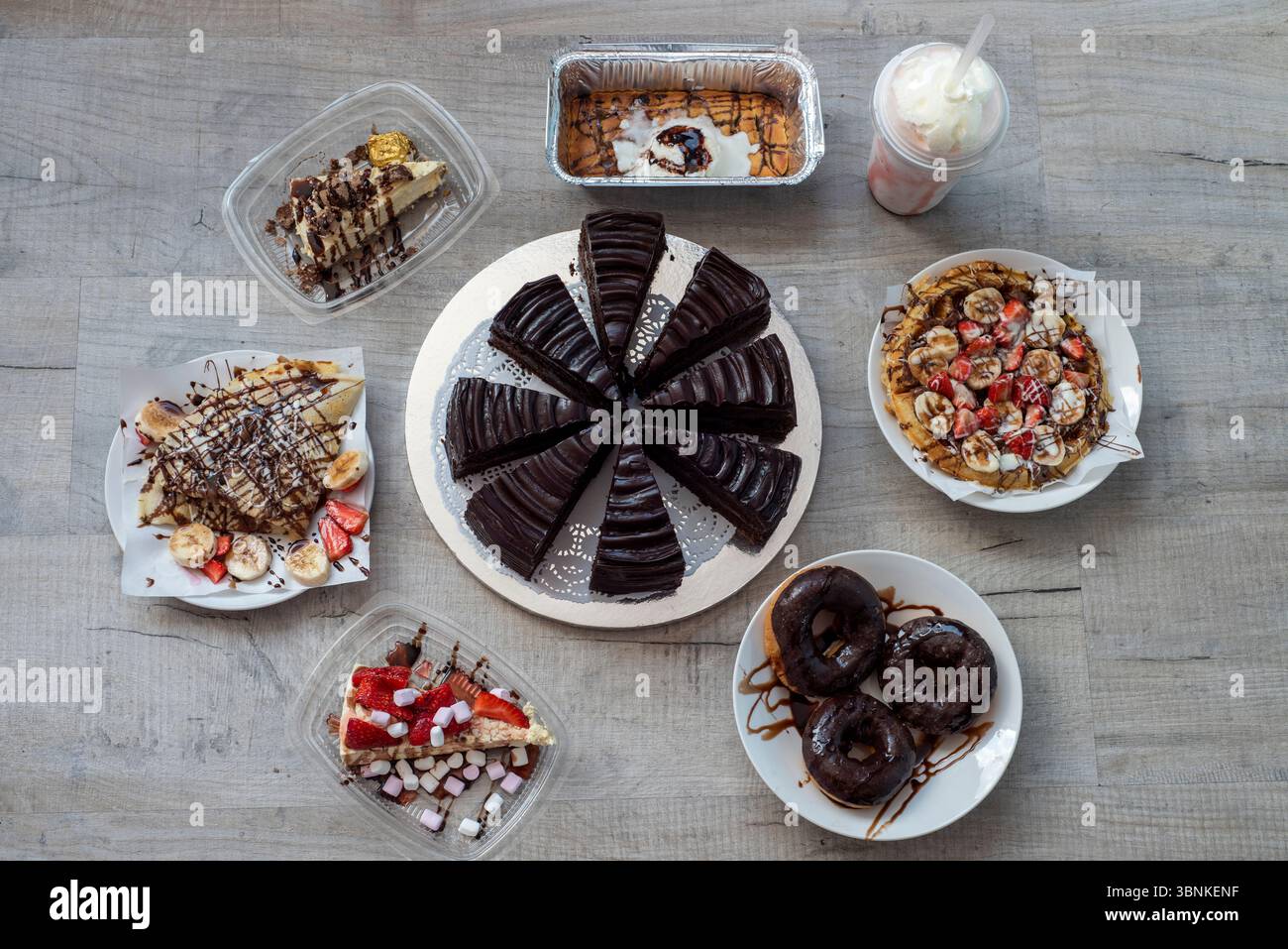 Una selezione di torte, dessert e frullati disponibili da mangiare al tavolo o da asporto Foto Stock