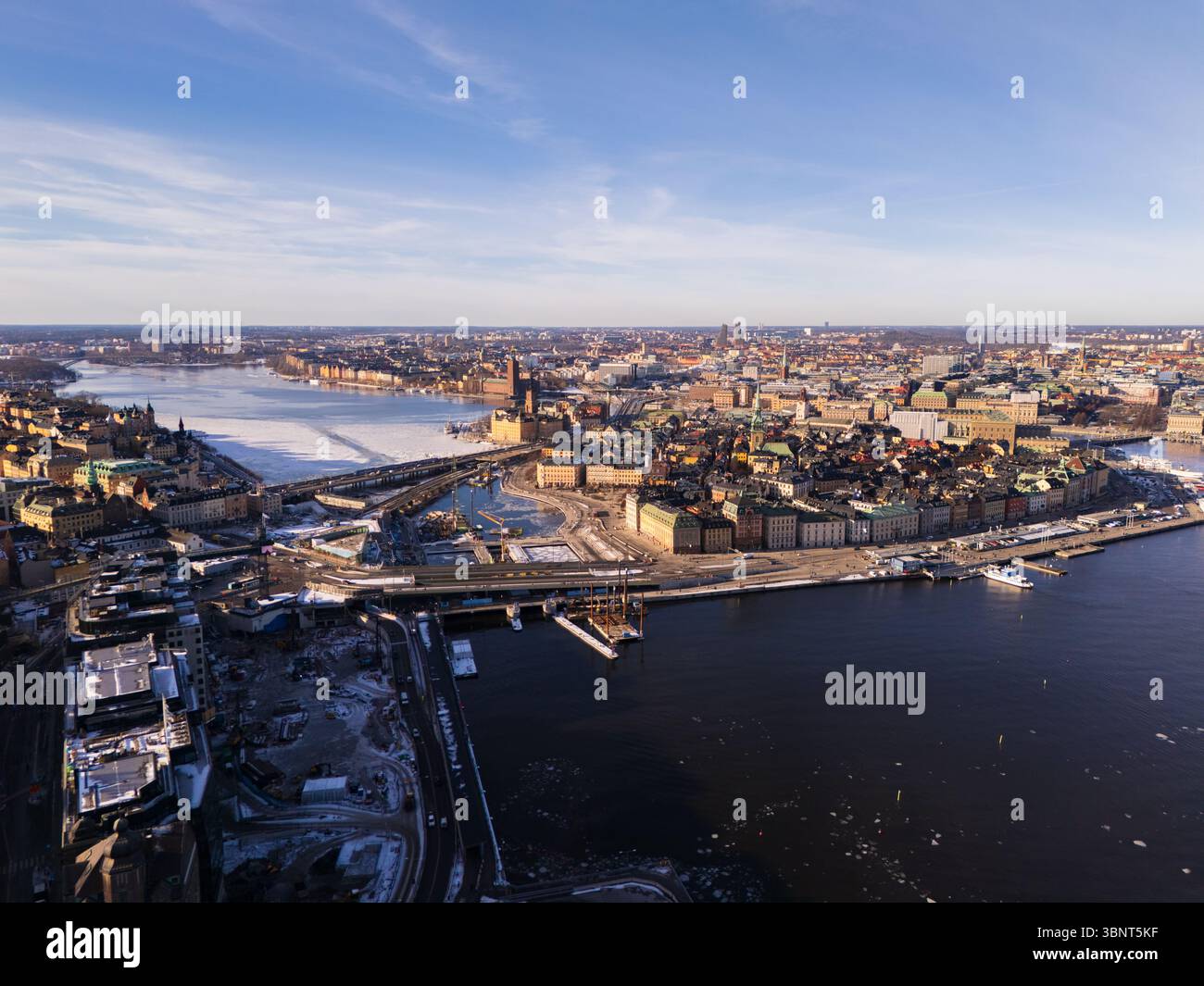 La vista aerea del fascino del vecchio mondo di Gamla Stan incontra le infrastrutture moderne, i ponti che collegano le isole tra le acque ghiacciate, Stoccolma, la contea di Stoccolma, Svezia. Foto Stock
