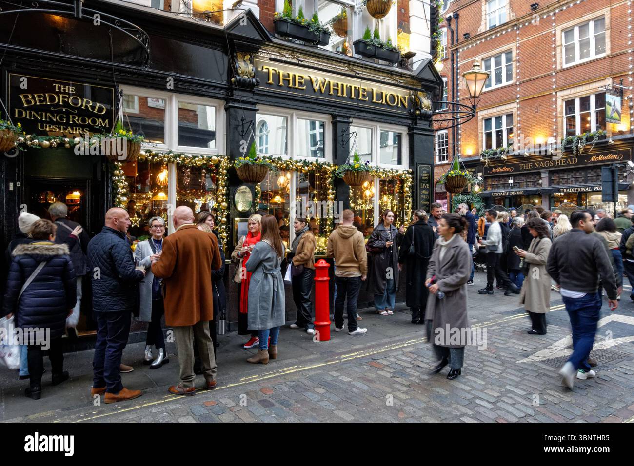 Persone che bevono fuori dal pub White Lion a Covent Garden, Londra Inghilterra Regno Unito Foto Stock