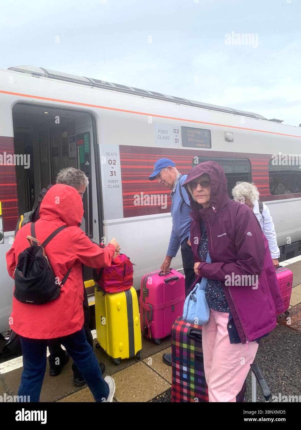 Treno da Inverness alla stazione ferroviaria di Kings Cross a Londra persone di prima classe imbarco cameriere cameriera persona in vacanza turisti valigie Regno Unito - Immagine stock catturata con smartphone