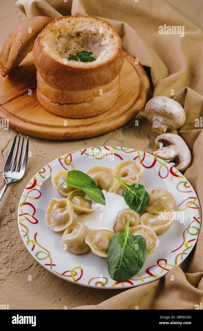 Natura morta alimentare, guanciali con basilico e crema di zuppa di funghi Foto Stock