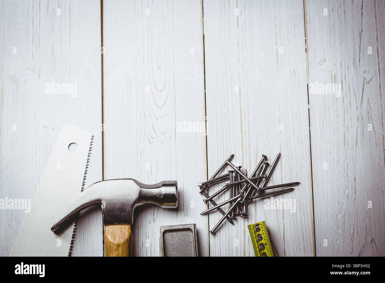 Illustrazione piatta che mostra il martello a baionetta con manico in legno accanto alla sega manuale, chiodi, nastro, spazio di copia Foto Stock