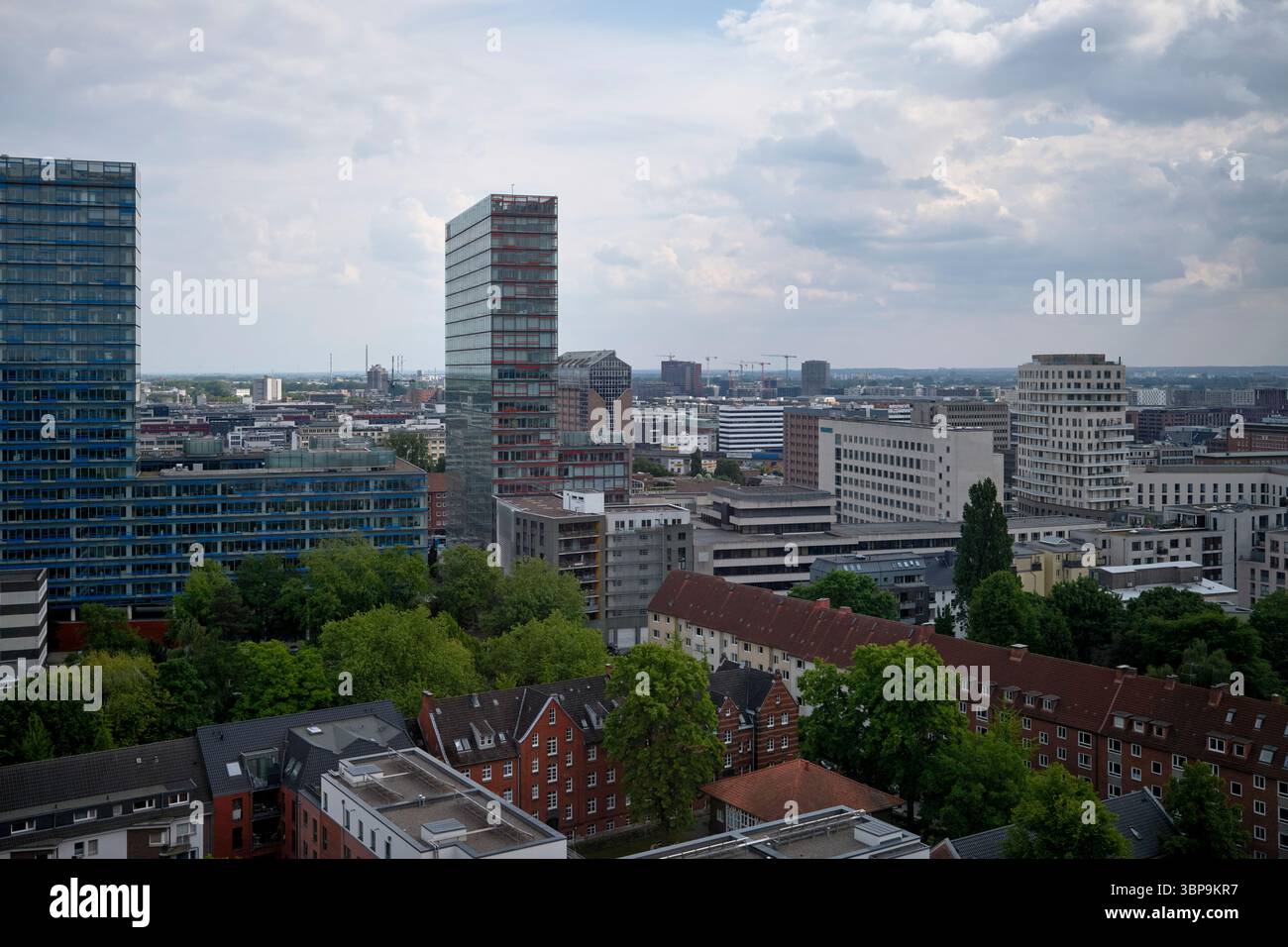 Skyline urbano con grattacieli moderni, edifici residenziali e vegetazione lussureggiante. Amburgo, Germania Foto Stock