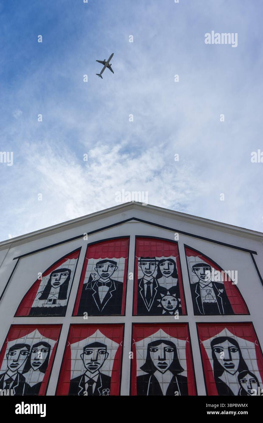 Aereo che vola sopra la moderna arte murale sulla facciata dell'edificio di Lisbona, Portogallo Foto Stock