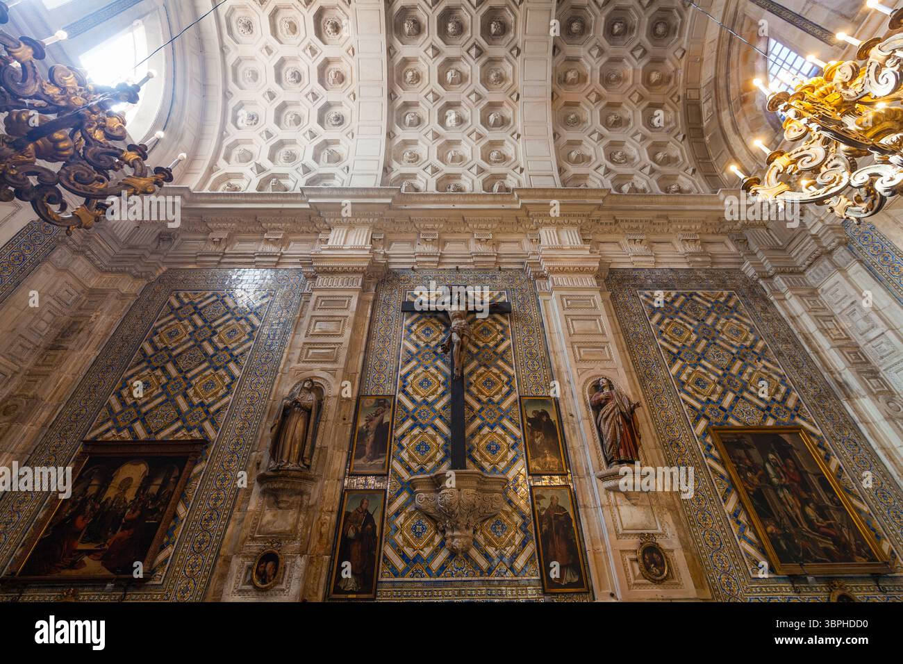 Uno splendido interno religioso presenta intricate piastrelle, una scena di crocifissione centrale, lampadari ornati e sculture dettagliate, creando un atmos Foto Stock